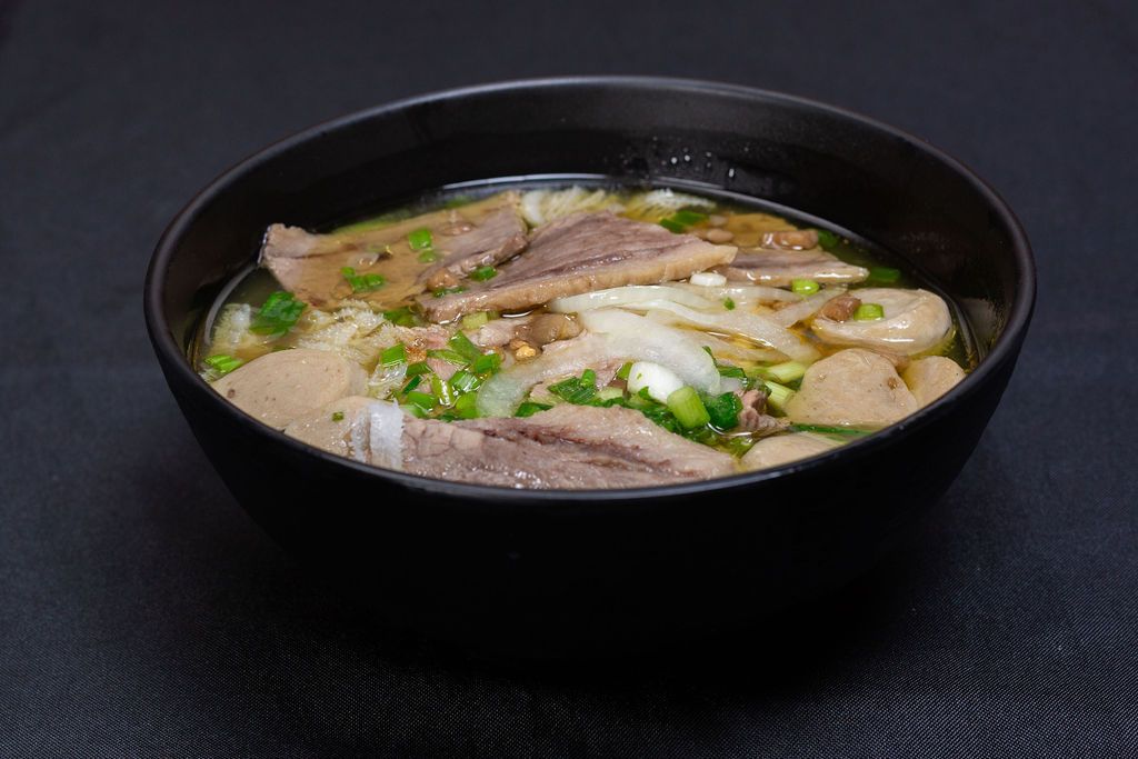 Bowl of beef pho with brisket and meatballs
