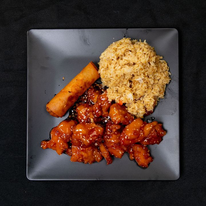 Sesame chicken entrée with fried rice and an egg roll