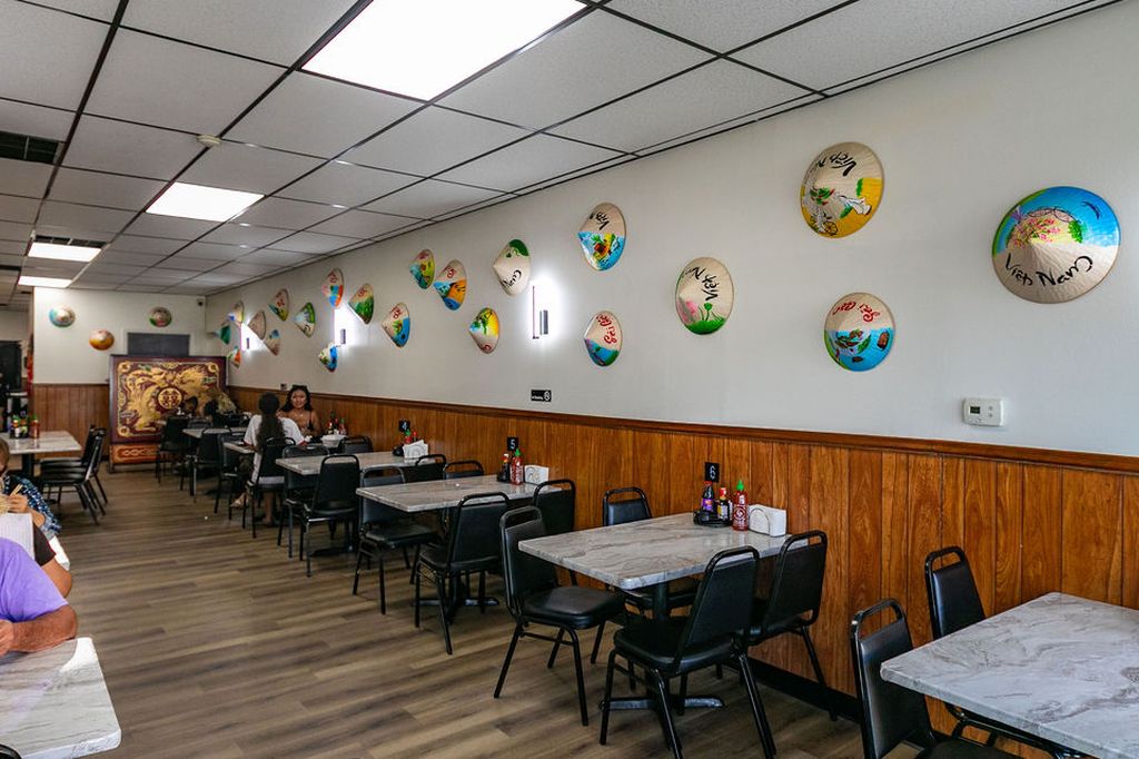 Wall of painted conical hats in the dining room