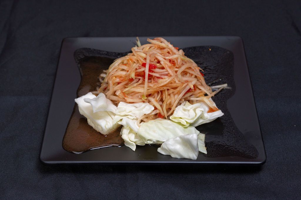 Green papaya salad on cabbage